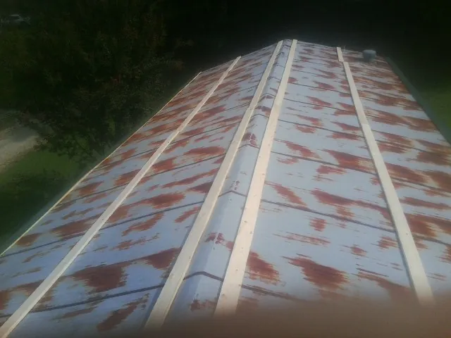 Rusted metal roof panels with new wood purlins before replacement — Storm Damage Roof Repair in Pottstown by Roofing Brothers