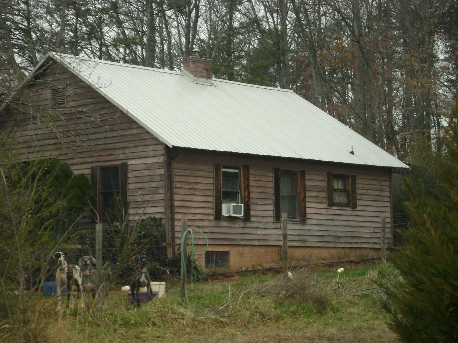White metal roof on an old wood sided farmhouse, from a Metal Roof Installation job in Pottstown